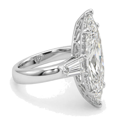 Large center marquise-cut diamond accented by tapered baguette side stones and delicate milgrain detailing.