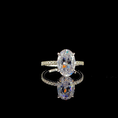 18k white gold engagement ring features a large 3.00 ct oval center diamond with a pave band.