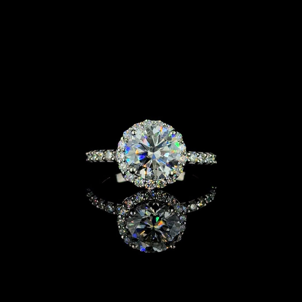 White gold round-cut diamond halo engagement ring.