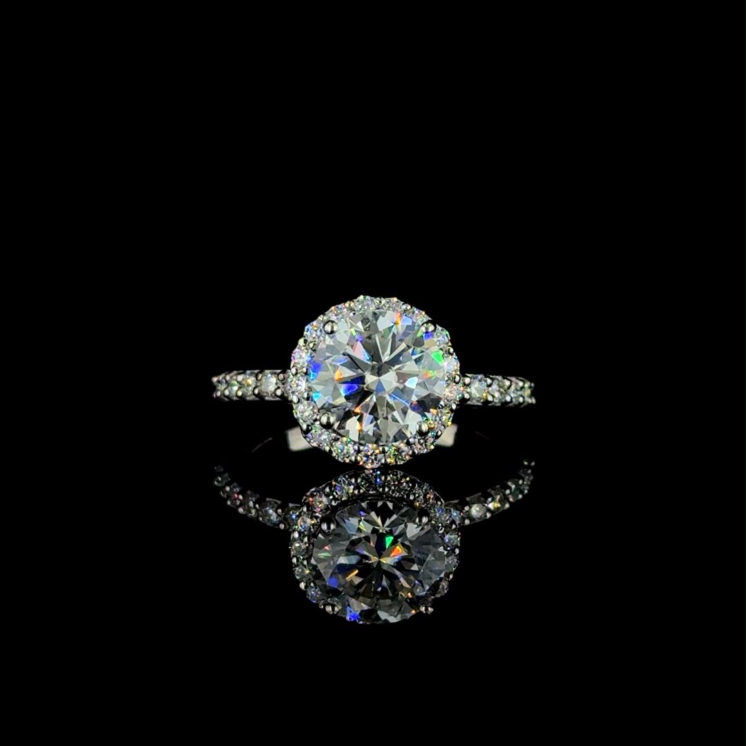 White gold round-cut diamond halo engagement ring.
