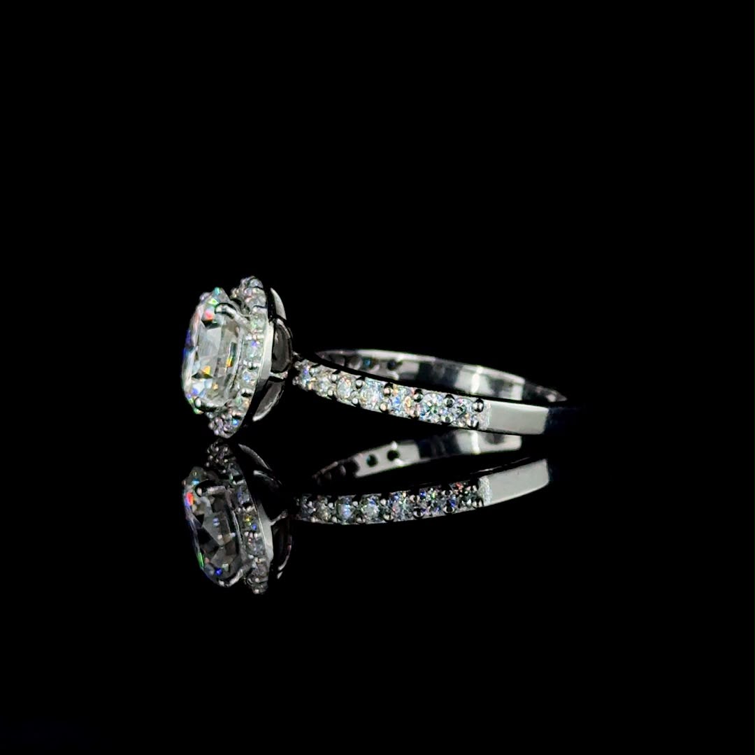 White gold round-cut diamond halo engagement ring.