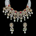 Uncut diamond with ruby red gems, green bead drops, and multi-strand pearl bead strings jewelry set.