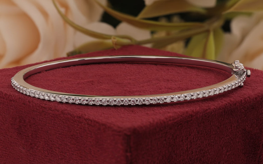 White gold band set with a shimmering row of brilliant-cut round accent stones and a secure box clasp closure.