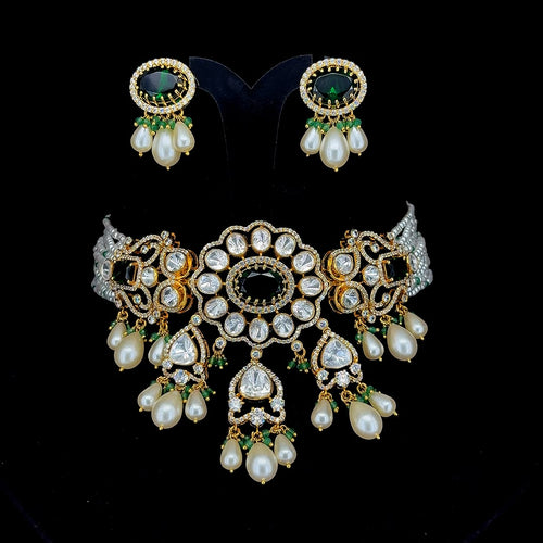 Emerald-green central stones and cascading pearl-and-bead drop accents kundan and pearl jewelry set.