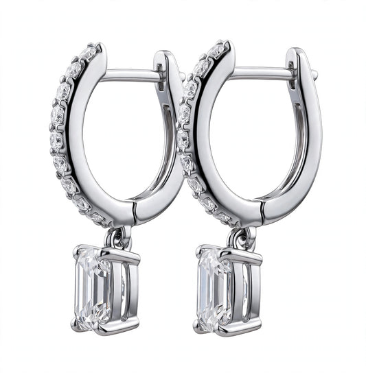 Emerald-cut diamond drop huggie earrings.