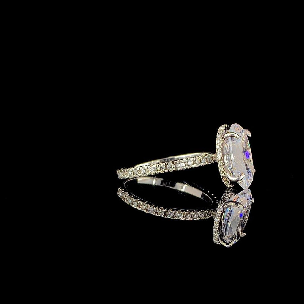 18k white gold engagement ring features a large 3.00 ct oval center diamond with a pave band.