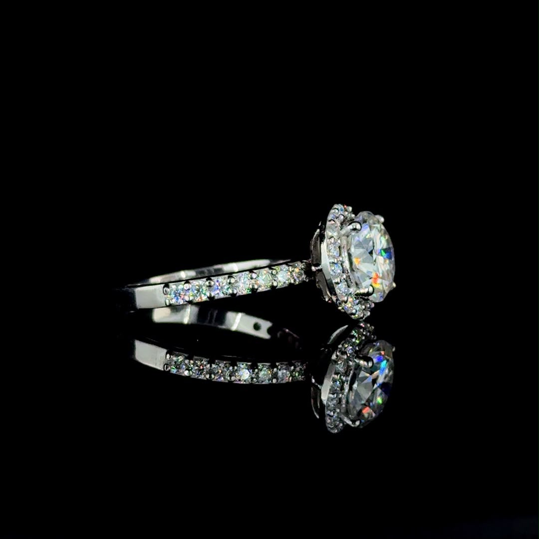 White gold round-cut diamond halo engagement ring.