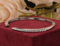 Round-cut white zirconia crystals open cuff bangle.